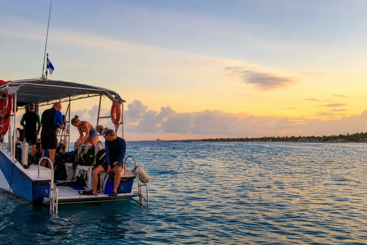 Divers preparing gear on a boat for a Cozumel reef trip
